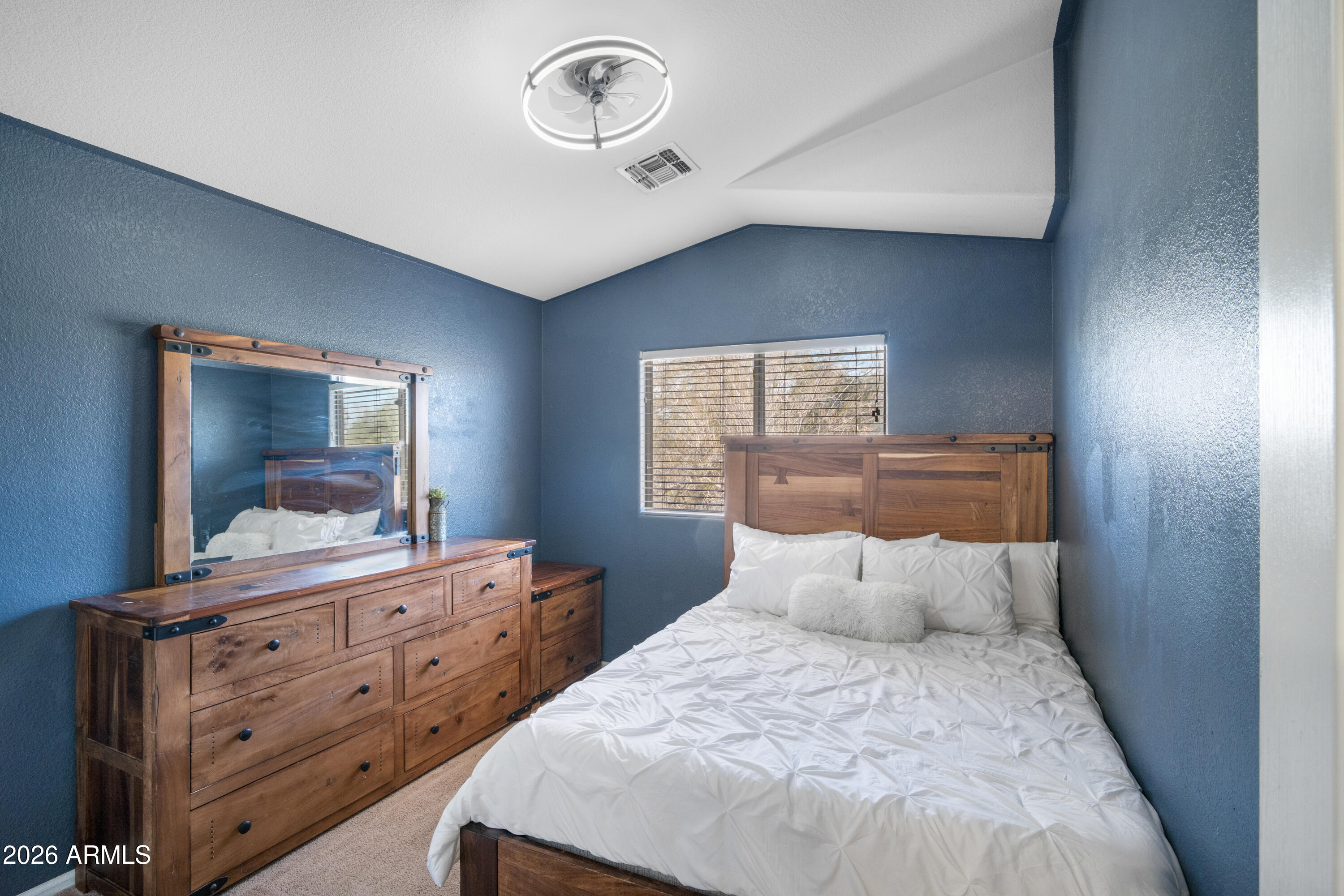 16221 West Latham Street Goodyear, AZ 85338 - Photo 21 of 30 a bedroom with a bed and a dresser