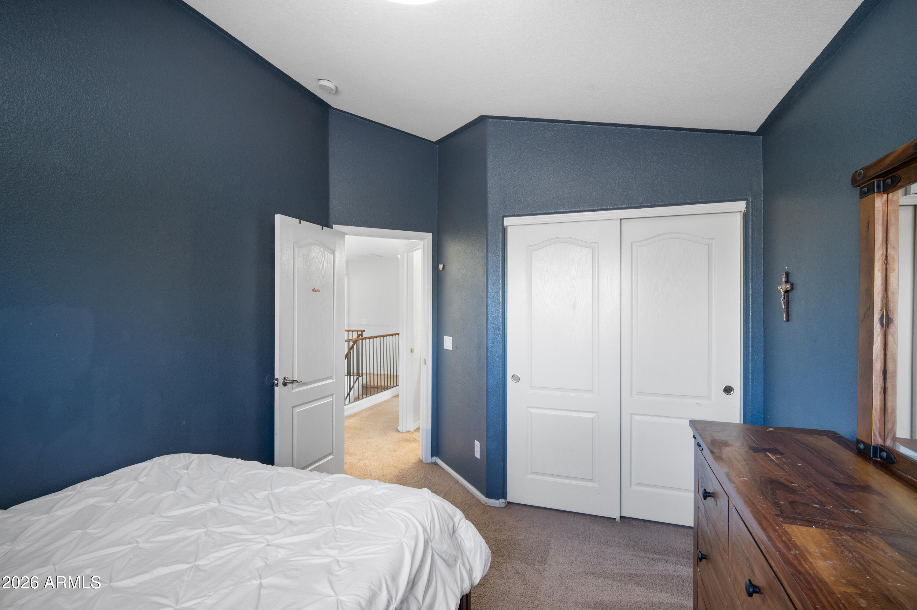16221 West Latham Street Goodyear, AZ 85338 - Photo 22 of 30 a bedroom with a bed and a dresser