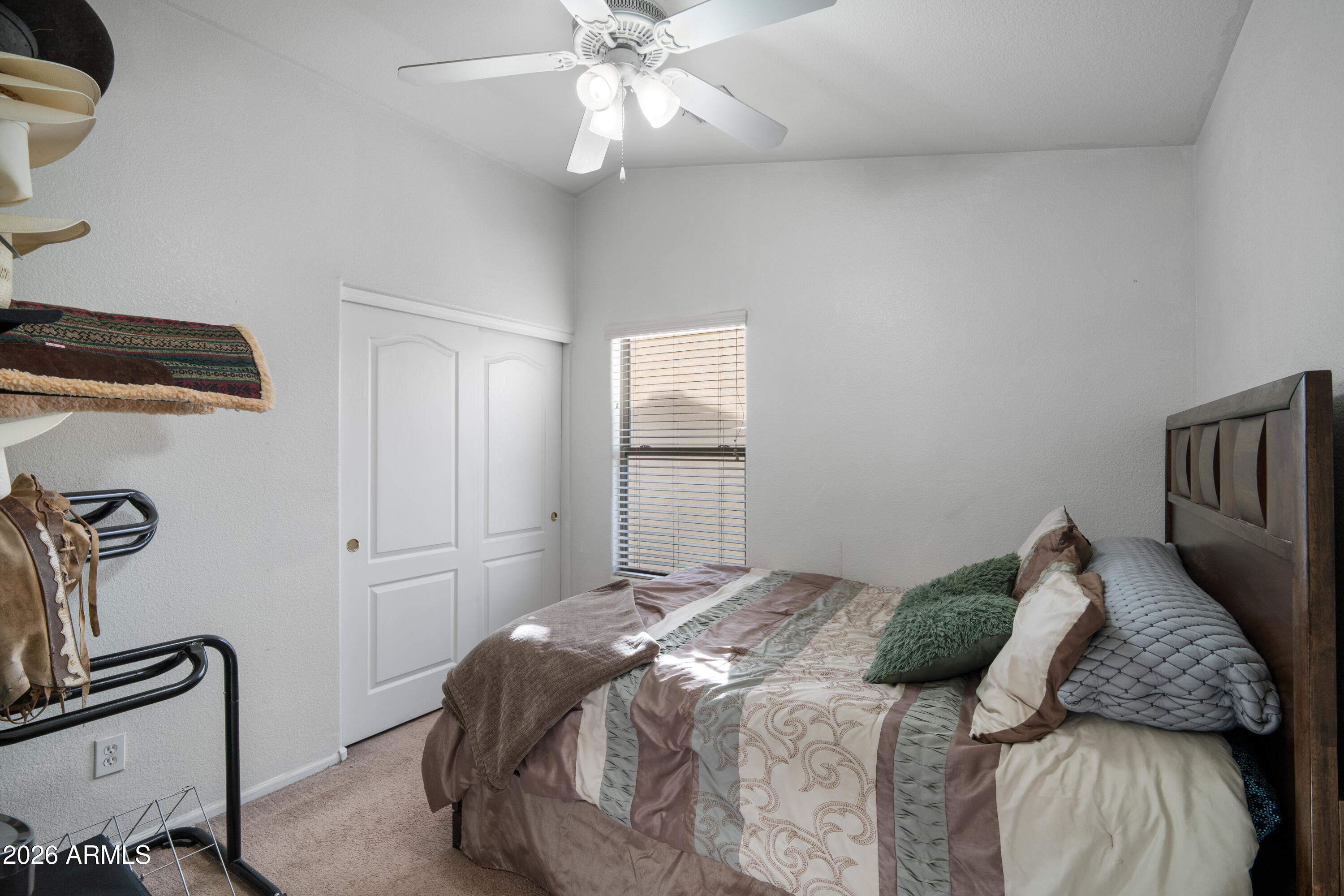 16221 West Latham Street Goodyear, AZ 85338 - Photo 23 of 30 a bedroom with a bed and ceiling fan