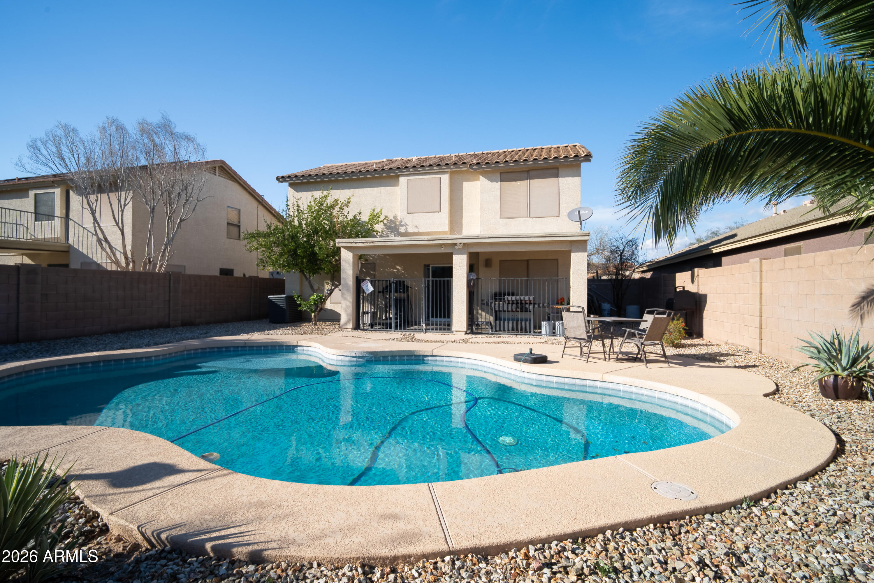 16221 West Latham Street Goodyear, AZ 85338 - Photo 27 of 30 a view of a house with swimming pool and sitting area