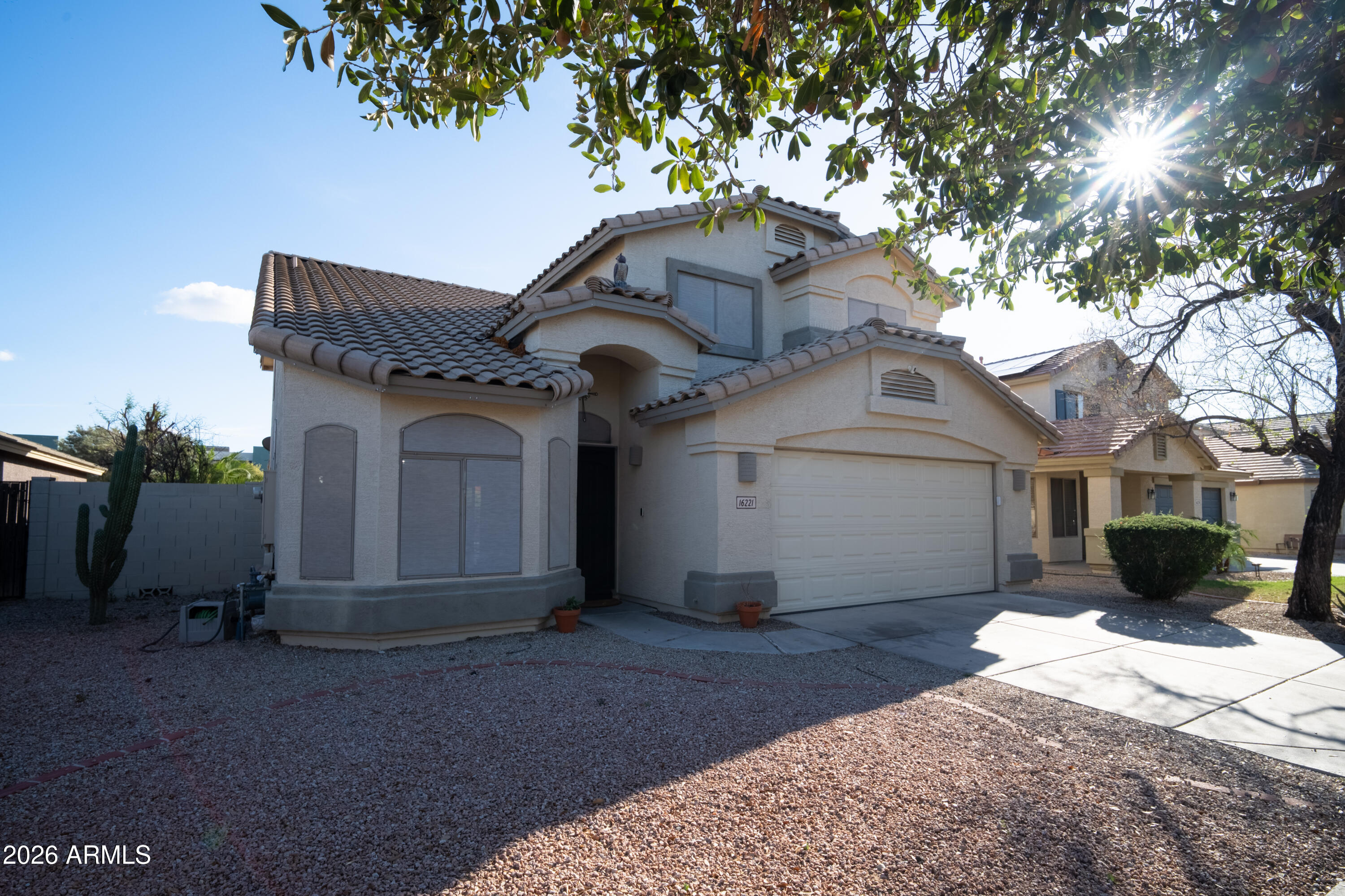 16221 West Latham Street Goodyear, AZ 85338 - Photo 3 of 30 a front view of a house with a yard