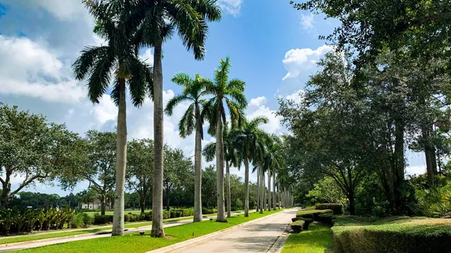 a view of swimming pool with outdoor seating and house in the background