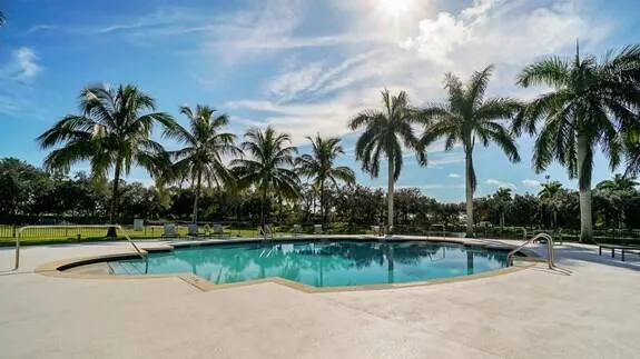 a view of a tennis court with a fan in the background