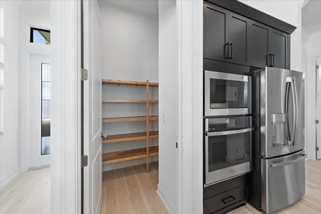 a kitchen with stainless steel appliances and refrigerator