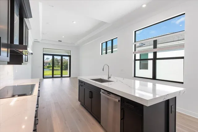 a kitchen with a sink stove and cabinets