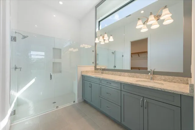 a bathroom with double sink and a mirror