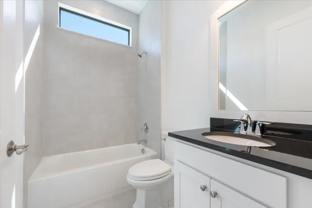 a bathroom with a sink a toilet and bathtub