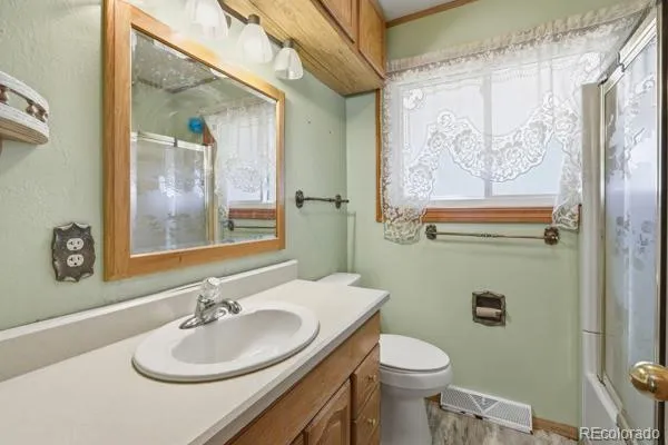 a bathroom with a sink a toilet and mirror