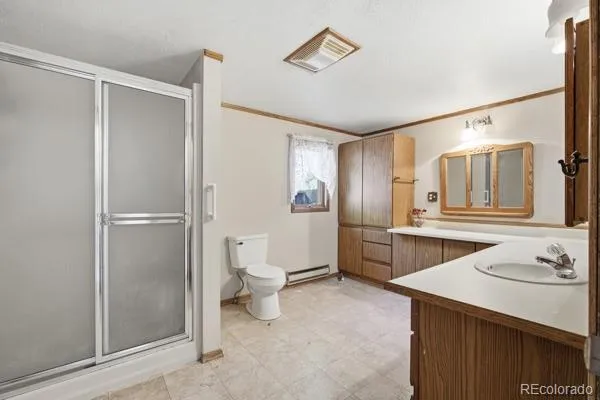 a bathroom with a sink toilet and shower