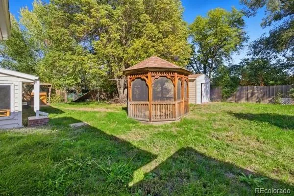 a front view of a house with yard and green space