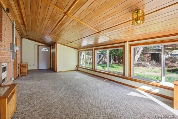 a view of a porch floor to ceiling window next to a yard