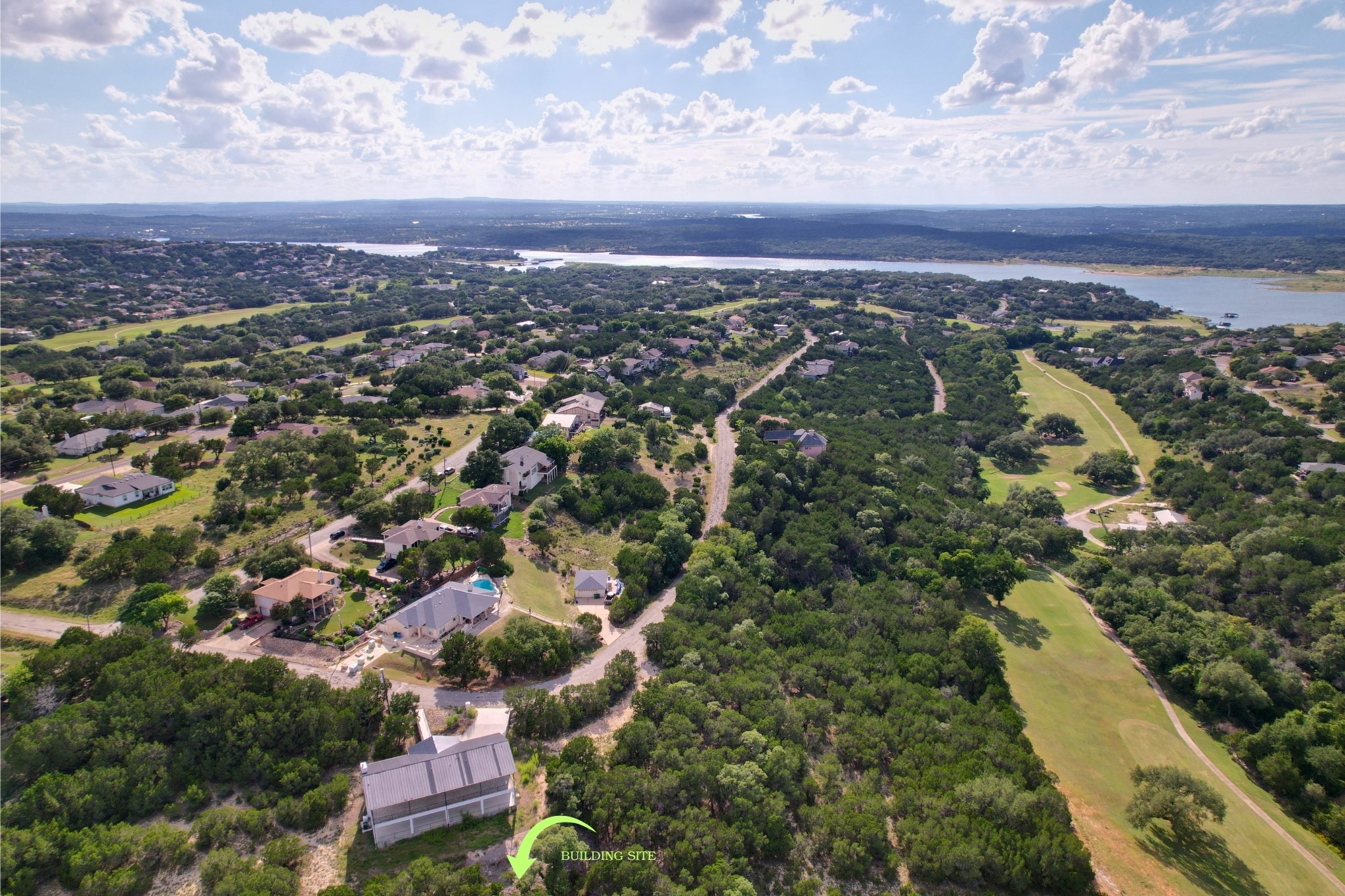 4500 Outpost Trace Leander, TX 78645 - Photo 6 of 13 A tranquil aerial perspective reveals a vast landscape dotted with homes, verdant trees, and a distant lake.