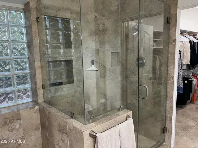 a view of a patio with table and chairs under an umbrella