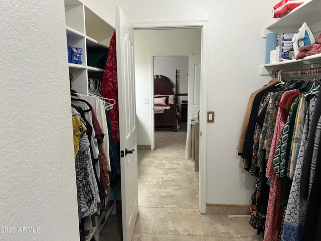 a front view of a house with a garden and trees