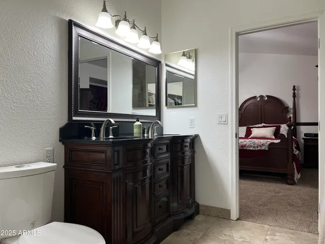 a view of a patio with table and chairs under an umbrella