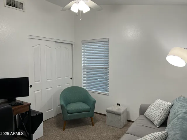 a view of a house with backyard porch and sitting area