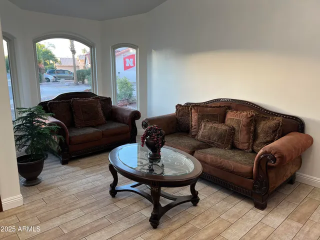 a view of a livingroom with wooden floor fireplace and stairs