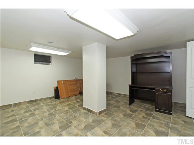 517 Gardner Street Raleigh, NC 27607 - Photo 16 of 21 Basement is completely finished and permitted with smooth ceilings, tile flooring, extra storage closet and great overhead lighting.