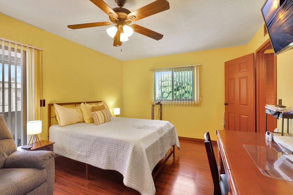278 Monaco Way, Unit F Delray Beach, FL 33446 - Photo 14 of 19 a bedroom with a bed and wooden floor