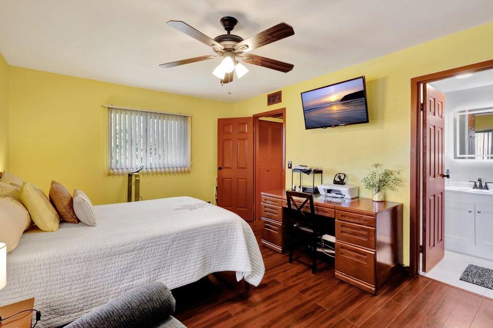 278 Monaco Way, Unit F Delray Beach, FL 33446 - Photo 15 of 19 a bedroom with a bed and wooden floor
