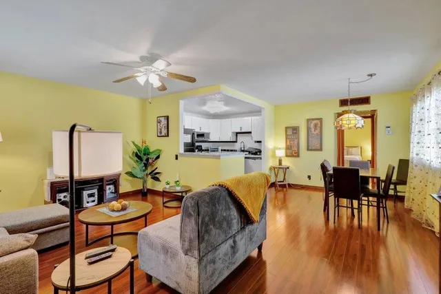 a living room with furniture dining table and a wooden floor