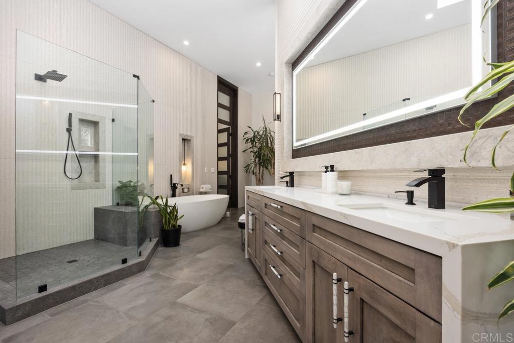 1240 Berryman Canyon Encinitas, CA 92024 - Photo 24 of 64 a spacious bathroom with a double vanity sink a mirror and shower