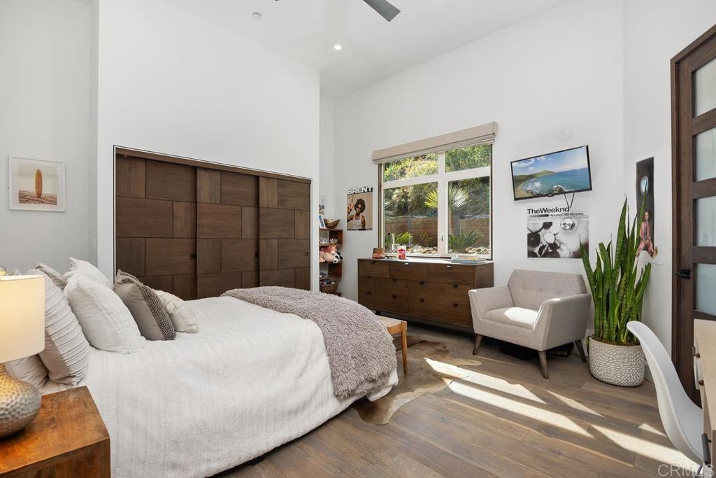 1240 Berryman Canyon Encinitas, CA 92024 - Photo 31 of 64 a bedroom with a balcony a bed and a couch