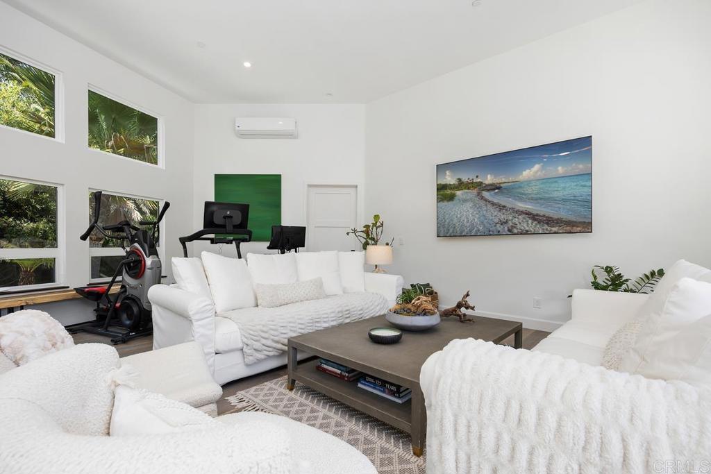1240 Berryman Canyon Encinitas, CA 92024 - Photo 38 of 64 a living room with furniture a couch and a flat screen tv