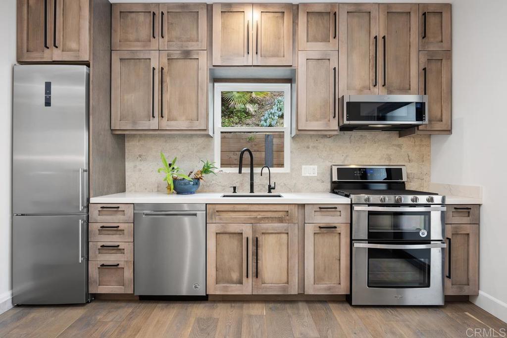 1240 Berryman Canyon Encinitas, CA 92024 - Photo 45 of 64 a kitchen with stainless steel appliances white cabinets and a sink