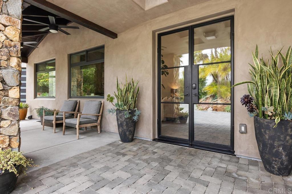 1240 Berryman Canyon Encinitas, CA 92024 - Photo 6 of 64 a view of a porch with a dining table and chairs
