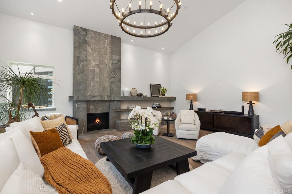 1240 Berryman Canyon Encinitas, CA 92024 - Photo 7 of 64 a living room with furniture a fireplace and a table