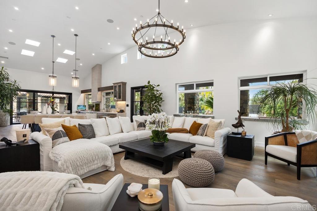 1240 Berryman Canyon Encinitas, CA 92024 - Photo 9 of 64 a living room with furniture a rug and a chandelier