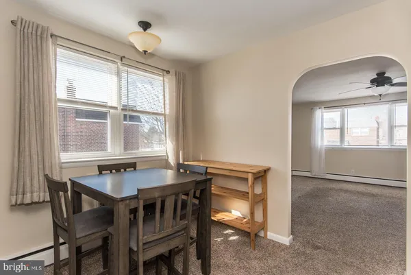 a dining room with wooden floor and a window