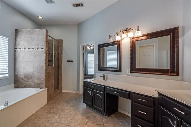 a bathroom with a double vanity sink and a bathtub
