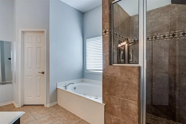 a bathroom with a bathtub and shower