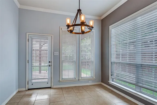 a view of wooden door windows and chandelier in a room