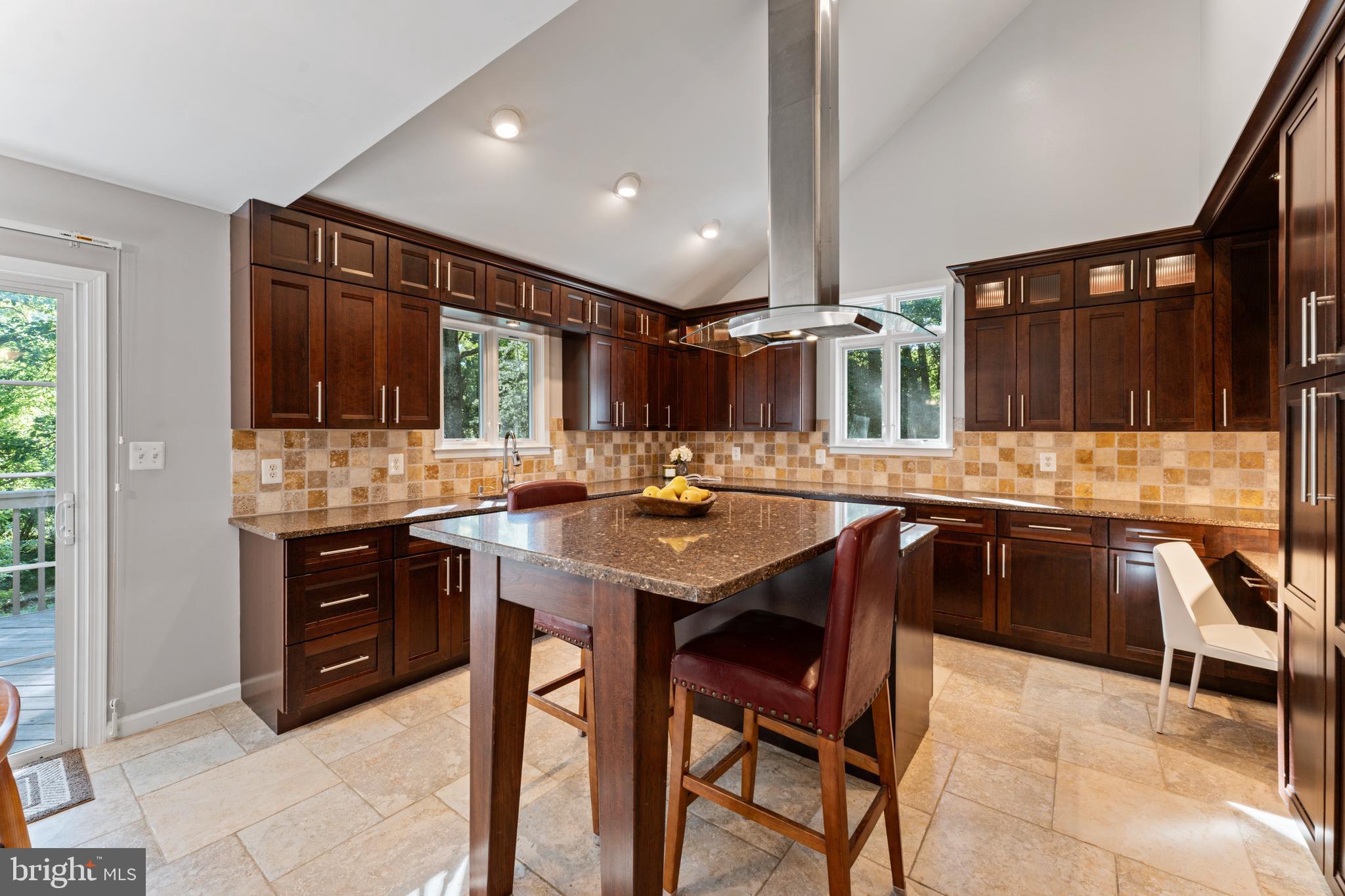1555 Wall Drive Pasadena, MD 21122 - Photo 12 of 46 a kitchen with a sink a stove and chairs