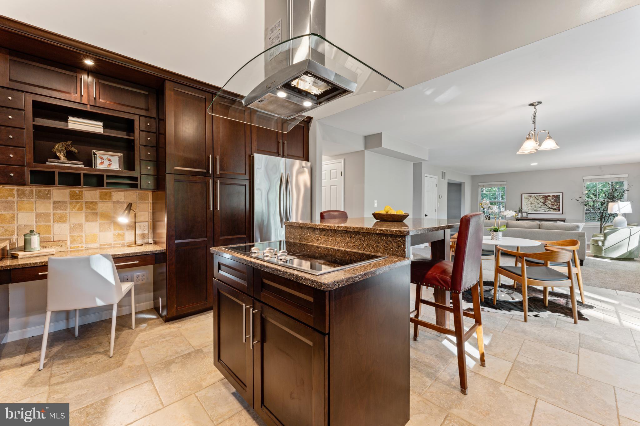 1555 Wall Drive Pasadena, MD 21122 - Photo 13 of 46 a kitchen with stainless steel appliances granite countertop a table chairs and a refrigerator