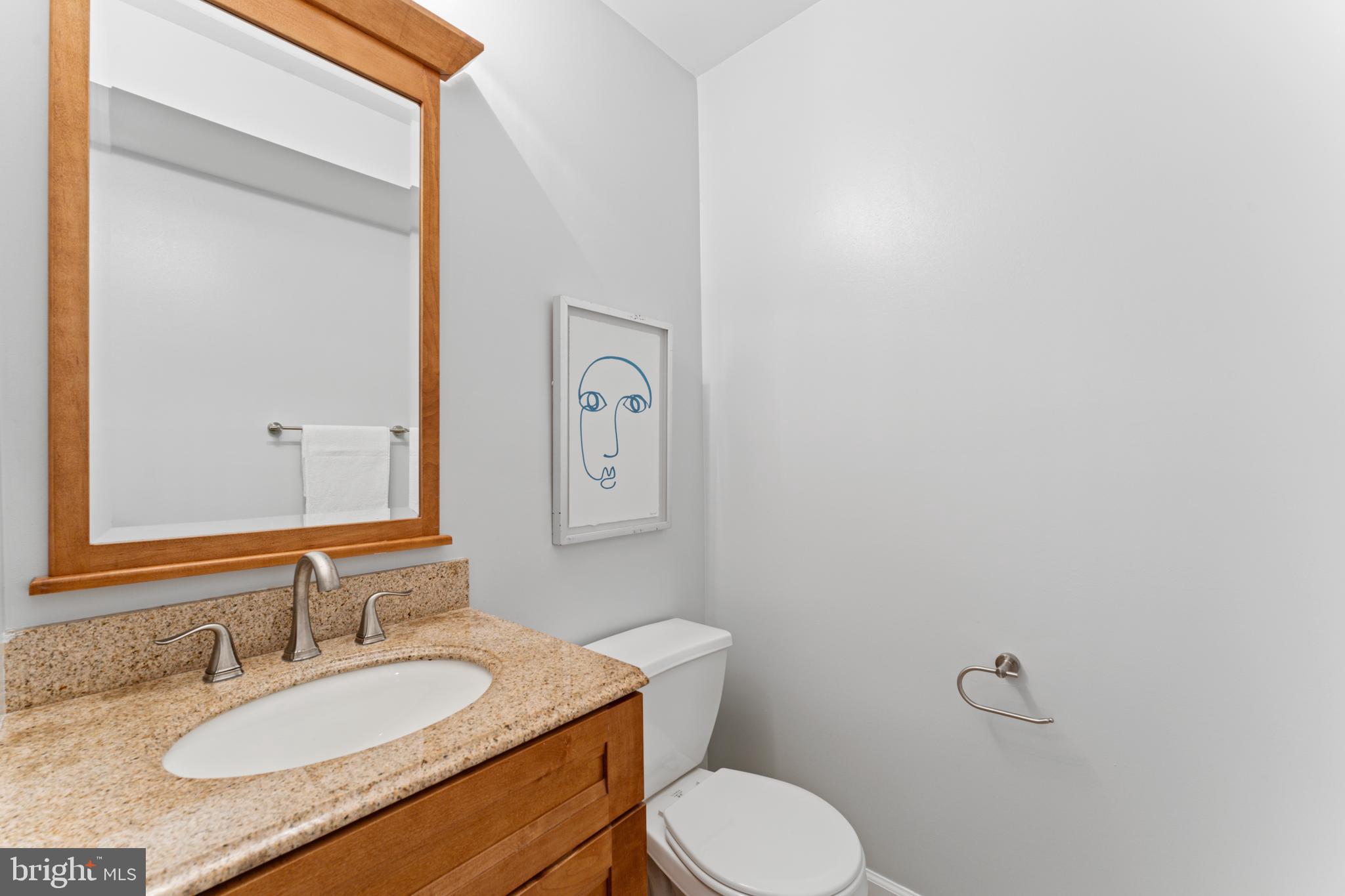 1555 Wall Drive Pasadena, MD 21122 - Photo 17 of 46 a bathroom with a granite countertop sink mirror vanity and toilet