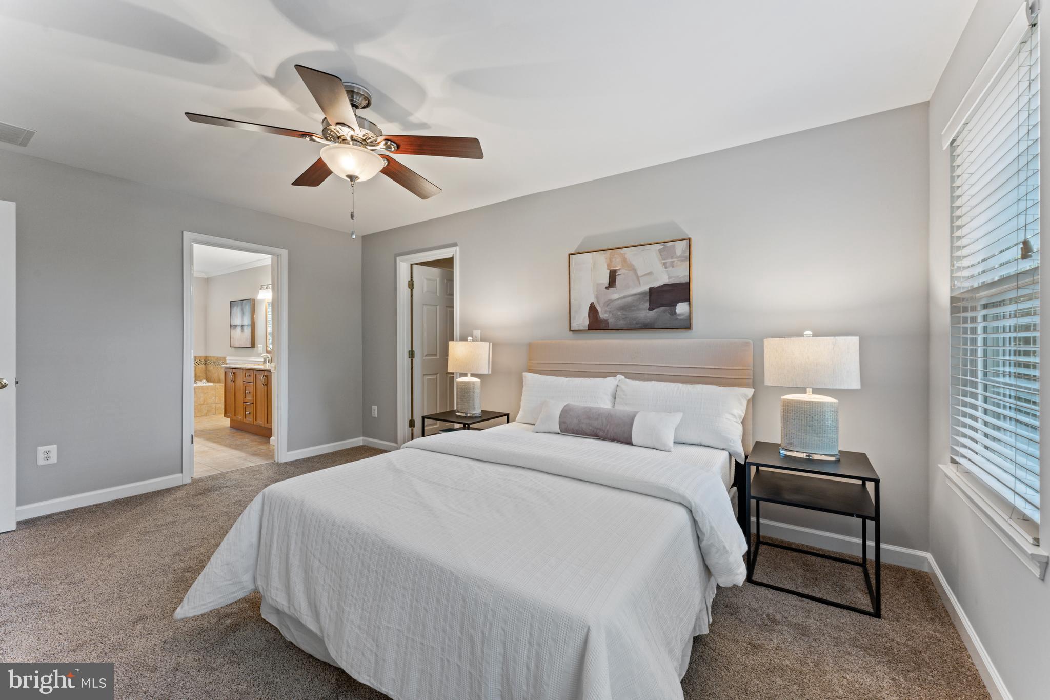 1555 Wall Drive Pasadena, MD 21122 - Photo 19 of 46 a bedroom with a bed and a chandelier