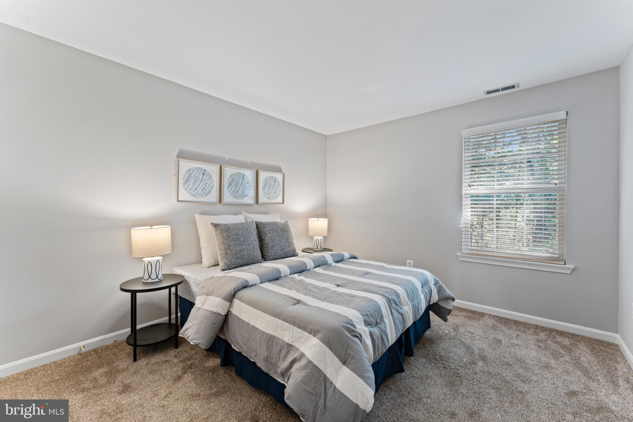 1555 Wall Drive Pasadena, MD 21122 - Photo 24 of 46 a bedroom with a bed and lamp