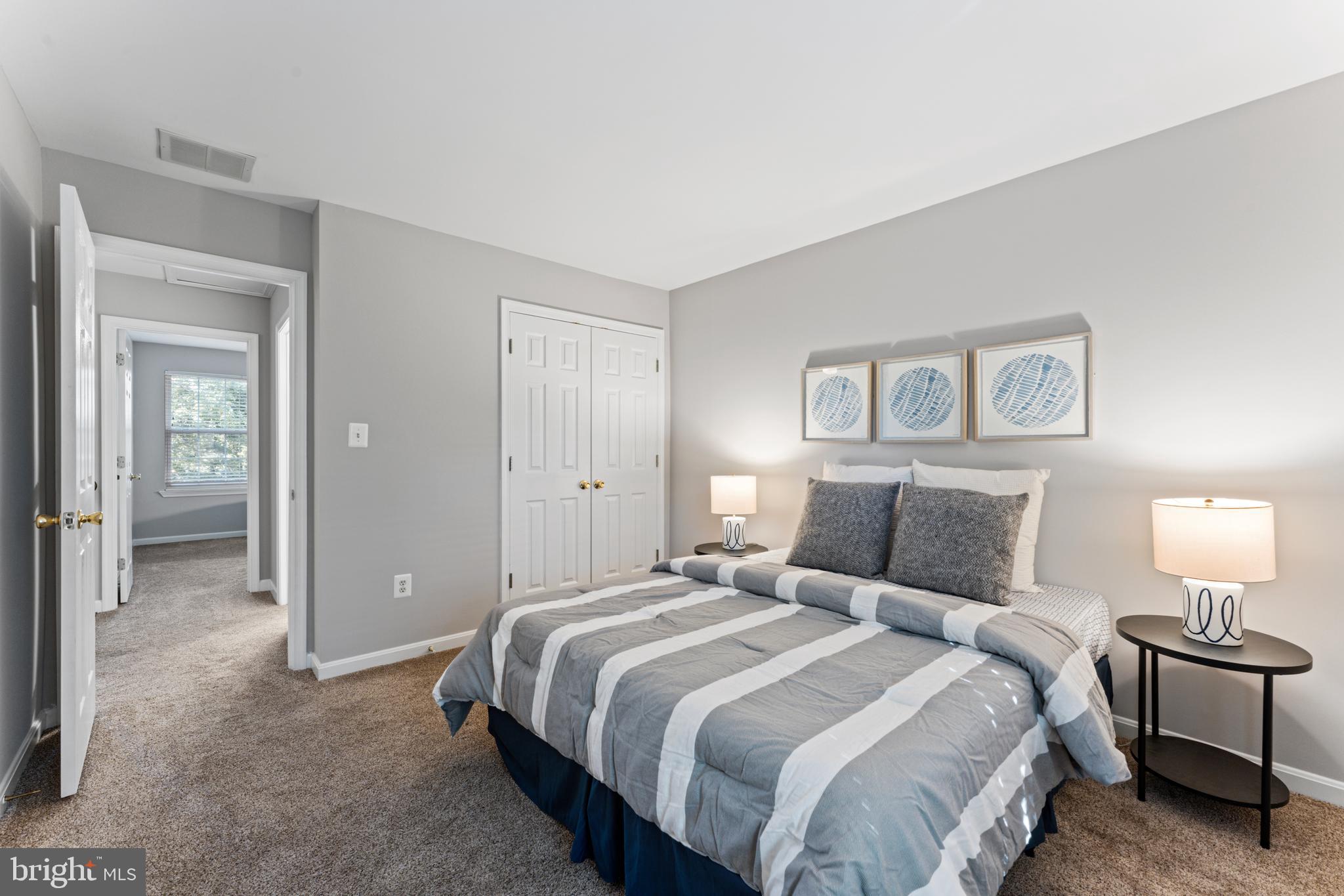 1555 Wall Drive Pasadena, MD 21122 - Photo 25 of 46 a bedroom with a bed and a lamp