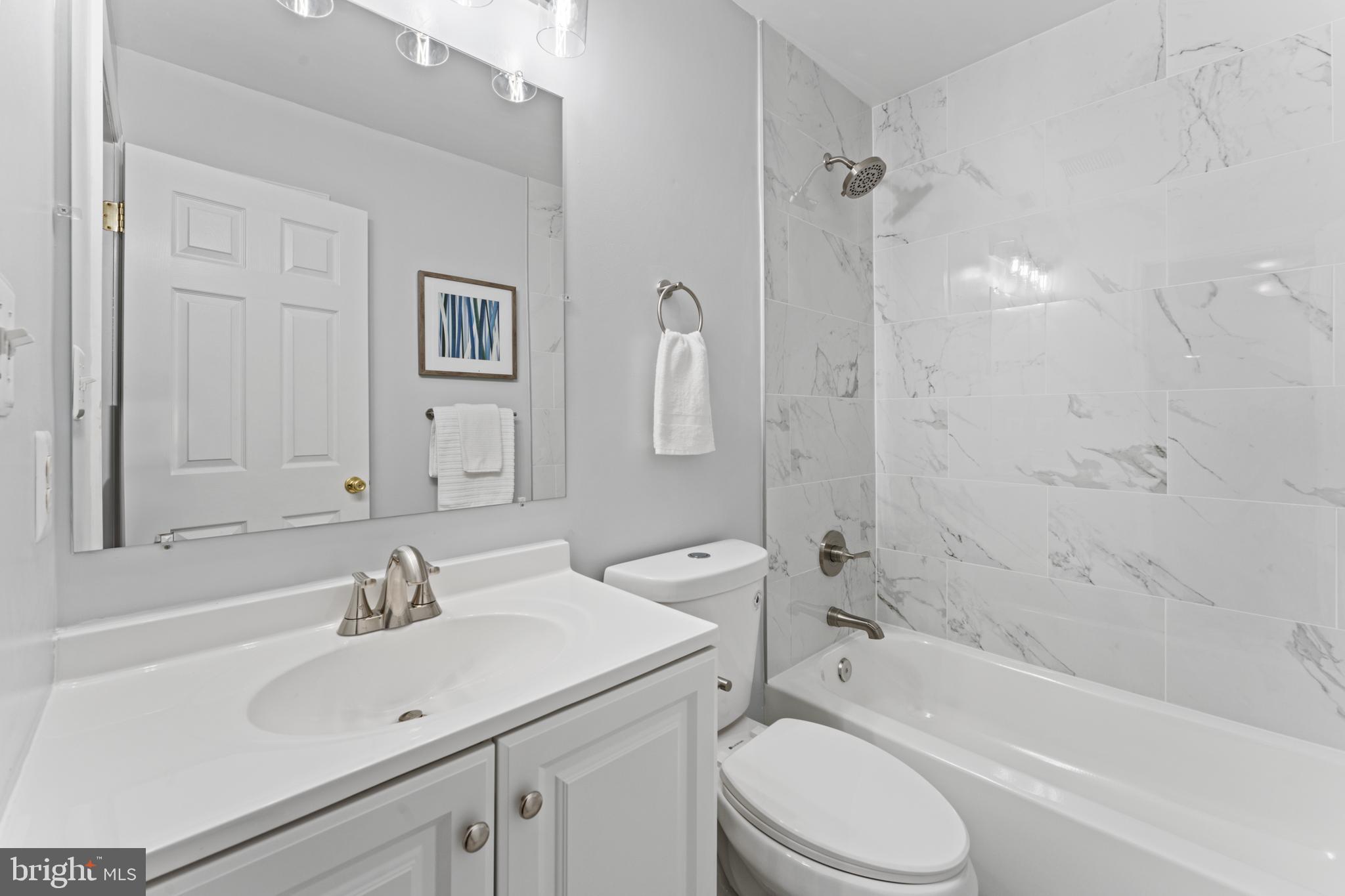 1555 Wall Drive Pasadena, MD 21122 - Photo 30 of 46 a bathroom with a sink toilet and shower