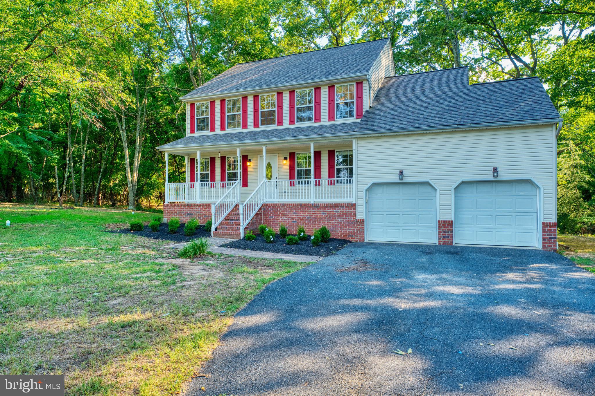 1555 Wall Drive Pasadena, MD 21122 - Photo 46 of 46 a front view of a house with a yard and garage