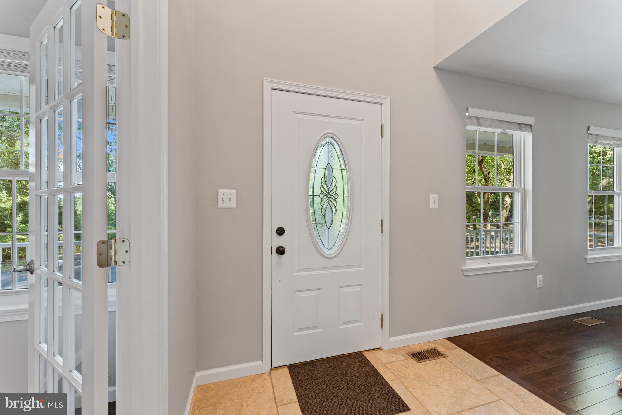 1555 Wall Drive Pasadena, MD 21122 - Photo 5 of 46 an entryway with wooden floor mirror and a window