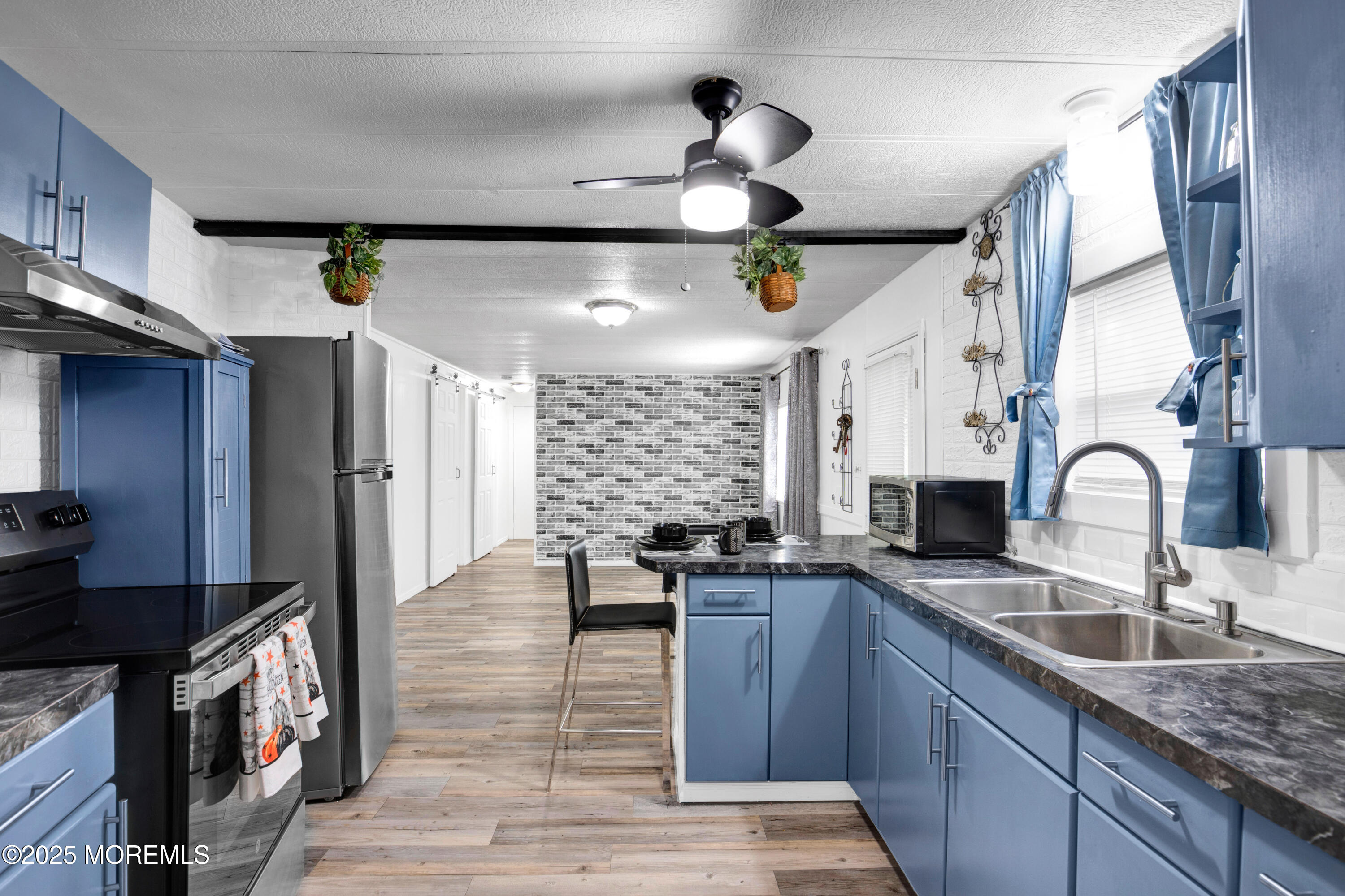 209 Mockingbird Way Whiting, NJ 08759 - Photo 11 of 26 a kitchen with stainless steel appliances granite countertop a sink a stove and a wooden floors