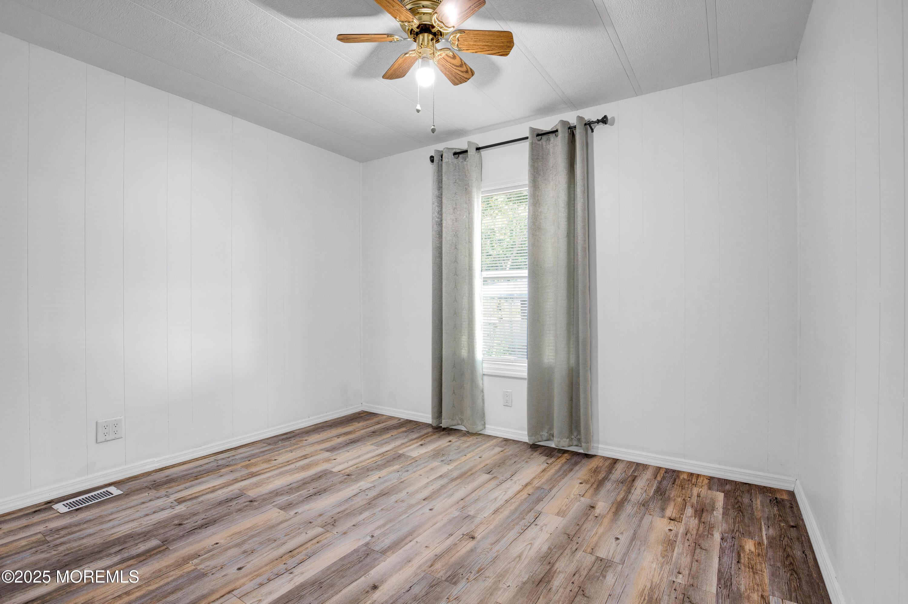 209 Mockingbird Way Whiting, NJ 08759 - Photo 15 of 26 wooden floor in an empty room with a window