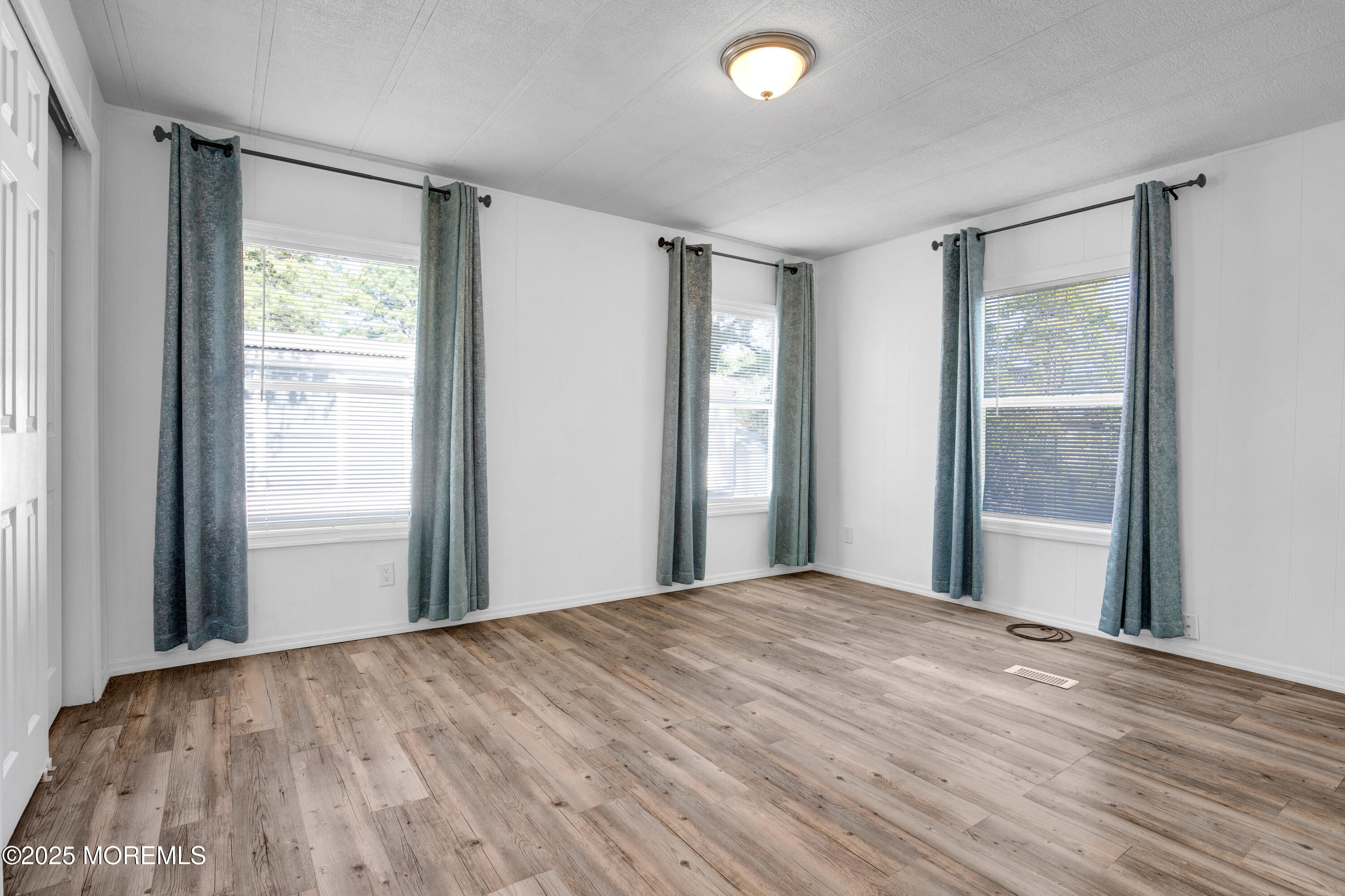 209 Mockingbird Way Whiting, NJ 08759 - Photo 19 of 26 a view of a livingroom with wooden floor and windows