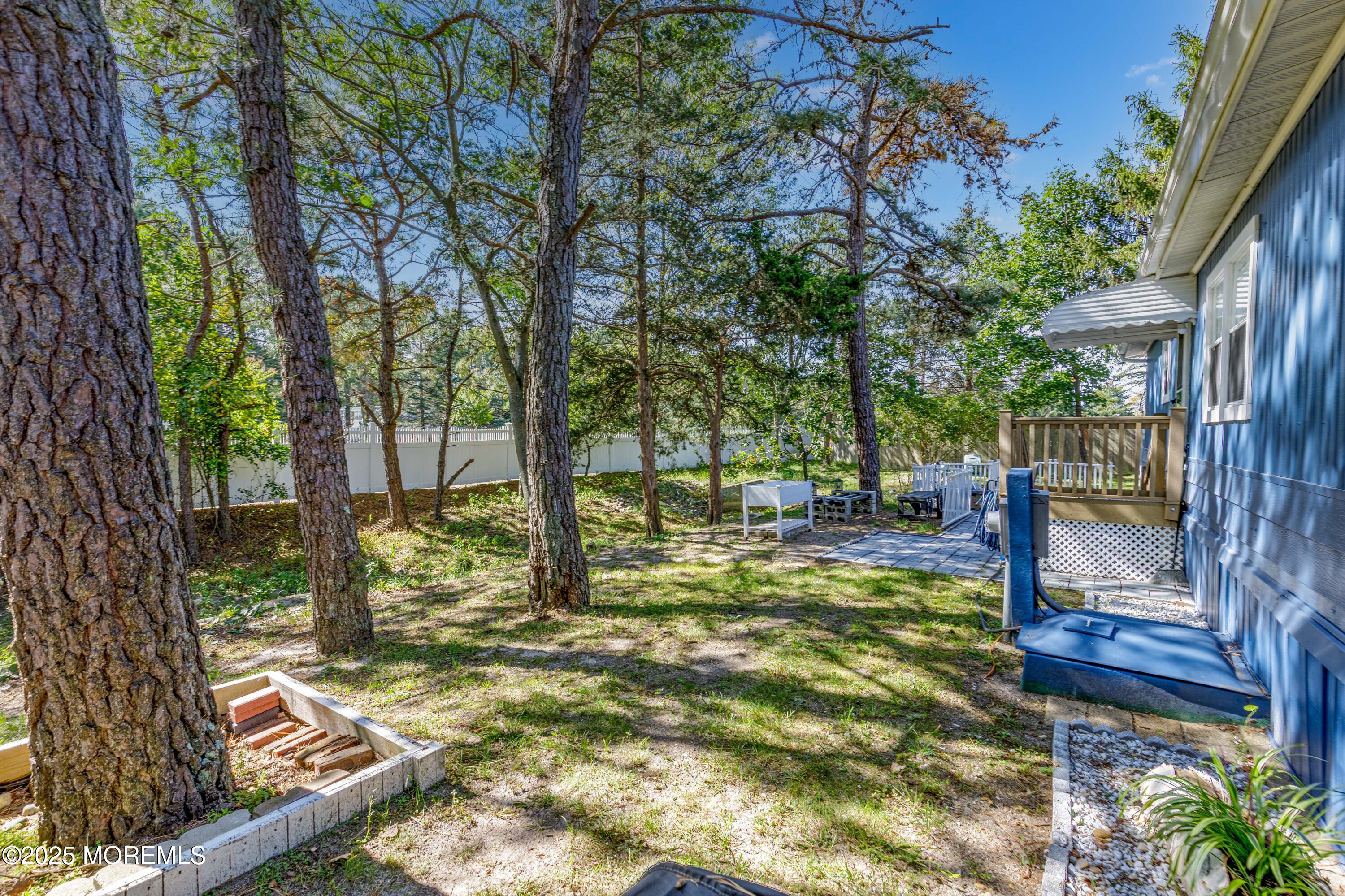 209 Mockingbird Way Whiting, NJ 08759 - Photo 25 of 26 a view of yard with deck and a large tree
