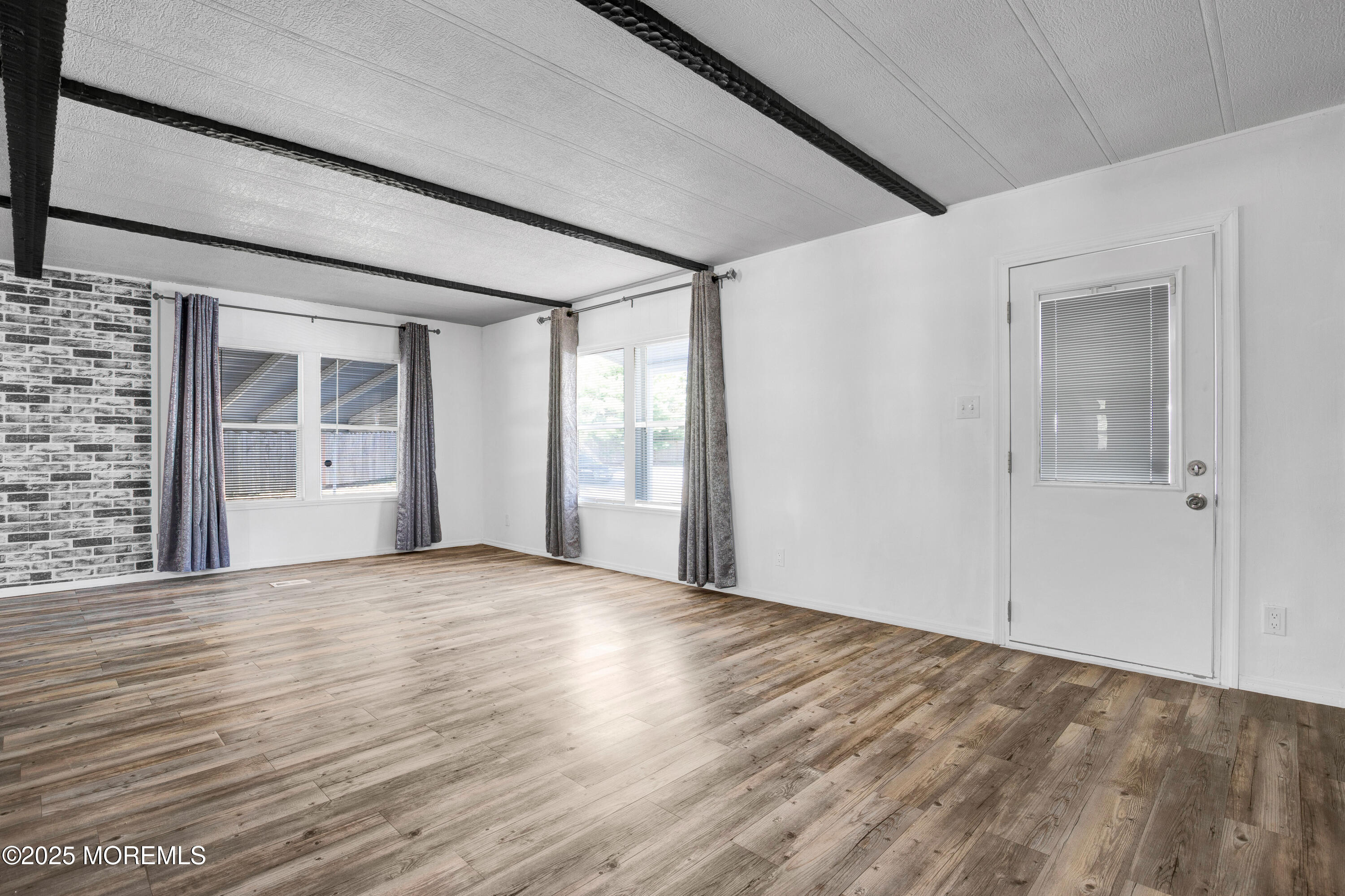 209 Mockingbird Way Whiting, NJ 08759 - Photo 4 of 26 a view of an empty room with wooden floor and a window